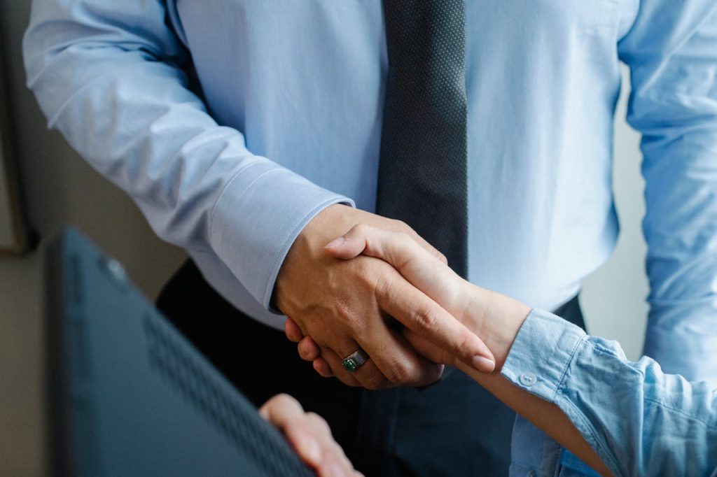 anonymous-colleagues-shaking-hands-before-business-meeting-5668834 High angle of crop unrecognizable male and female business partners in formal clothes shaking hands after successful deal
